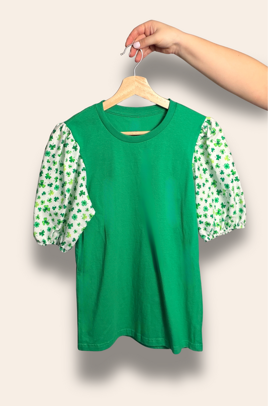 Your lucky outfit just found you.

Our Lucky Charm Puff Tee features a vibrant green base with the sweetest shamrock puff sleeves for the perfect festive glow-up. Playful, feminine, and made to stand out, it’s perfect for St. Patrick’s Day celebrations and all your lucky girl moments.

Limited edition and made to bring a little extra luck and a lot of cute.